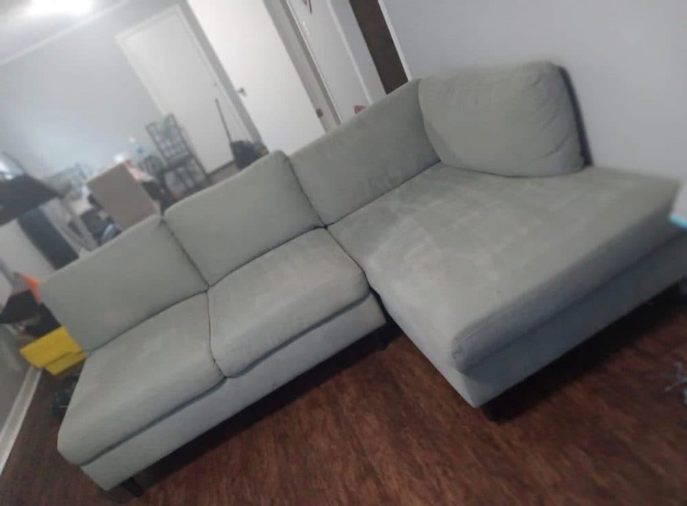 A light gray sectional sofa after cleaning
